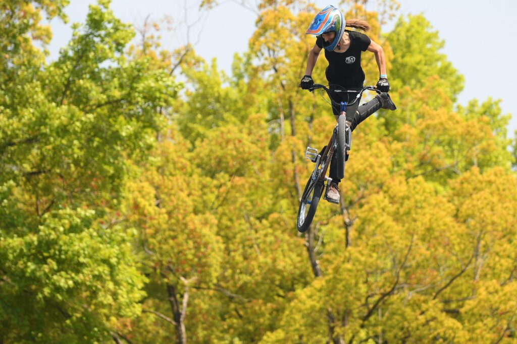 Chelsea Wolfe doing a trick on her bike.